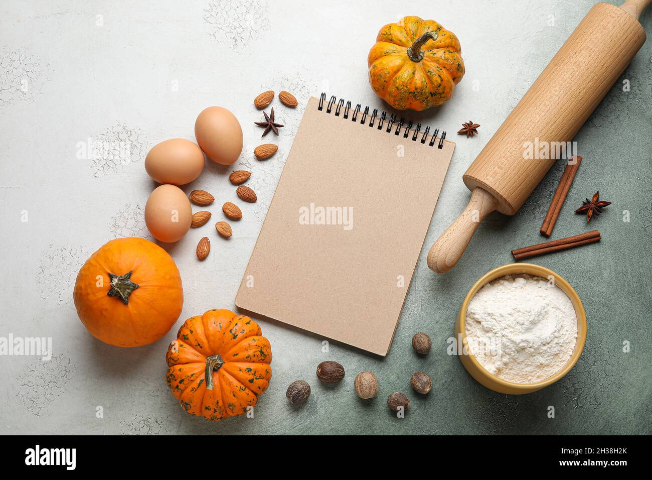 Ingredients for preparing pumpkin pie and notebook on table Stock Photo