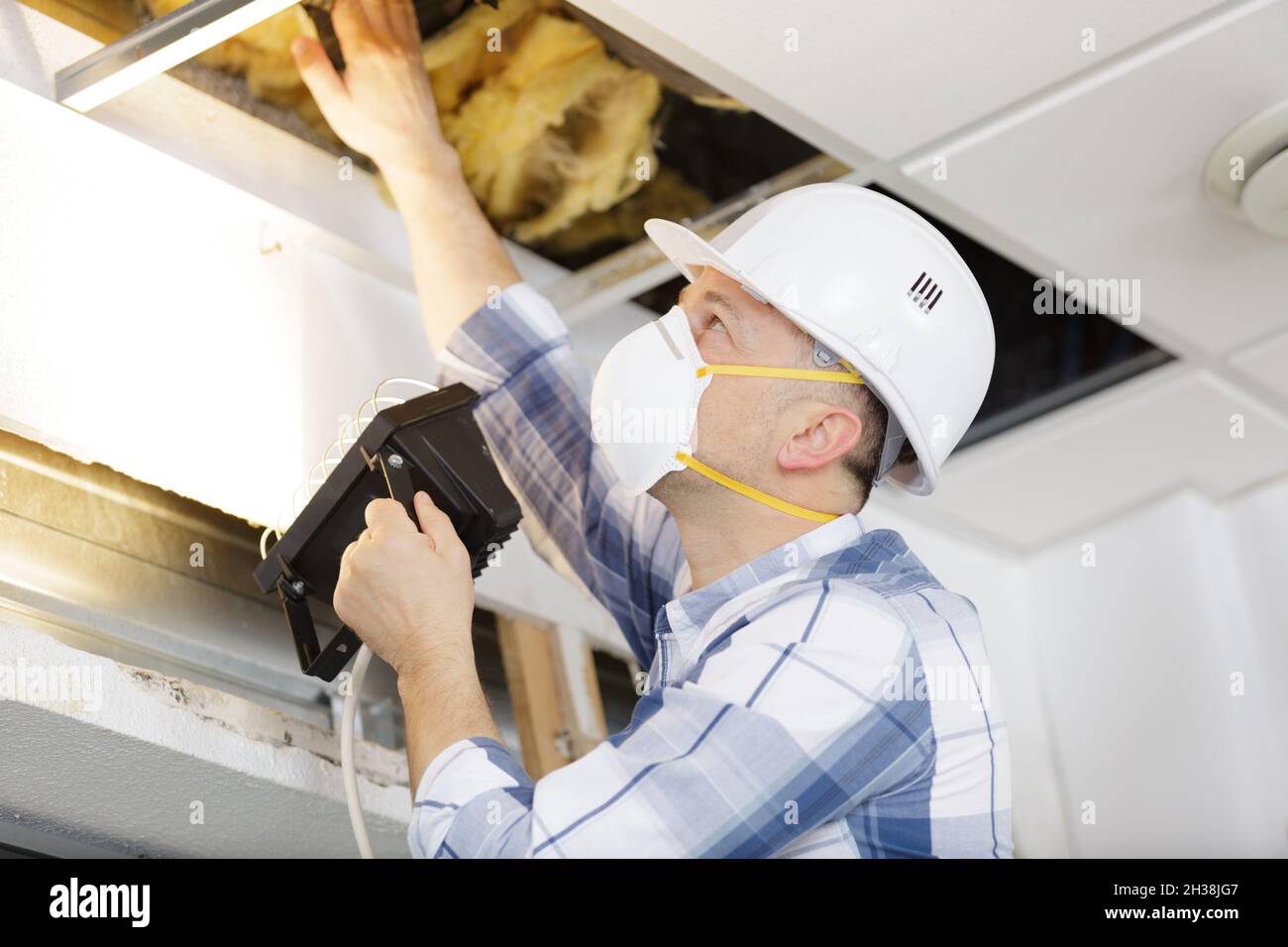 a man is working on home insulation work Stock Photo - Alamy