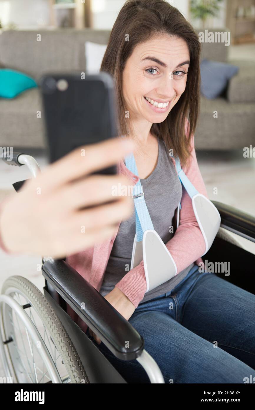 injured woman in a wheelchair taking a selfie Stock Photo - Alamy