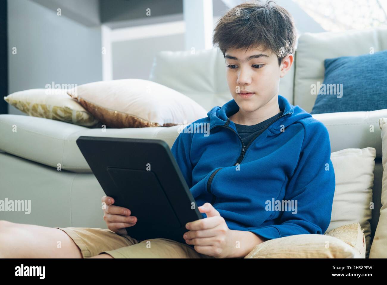 The boy using tablet at home. Stock Photo