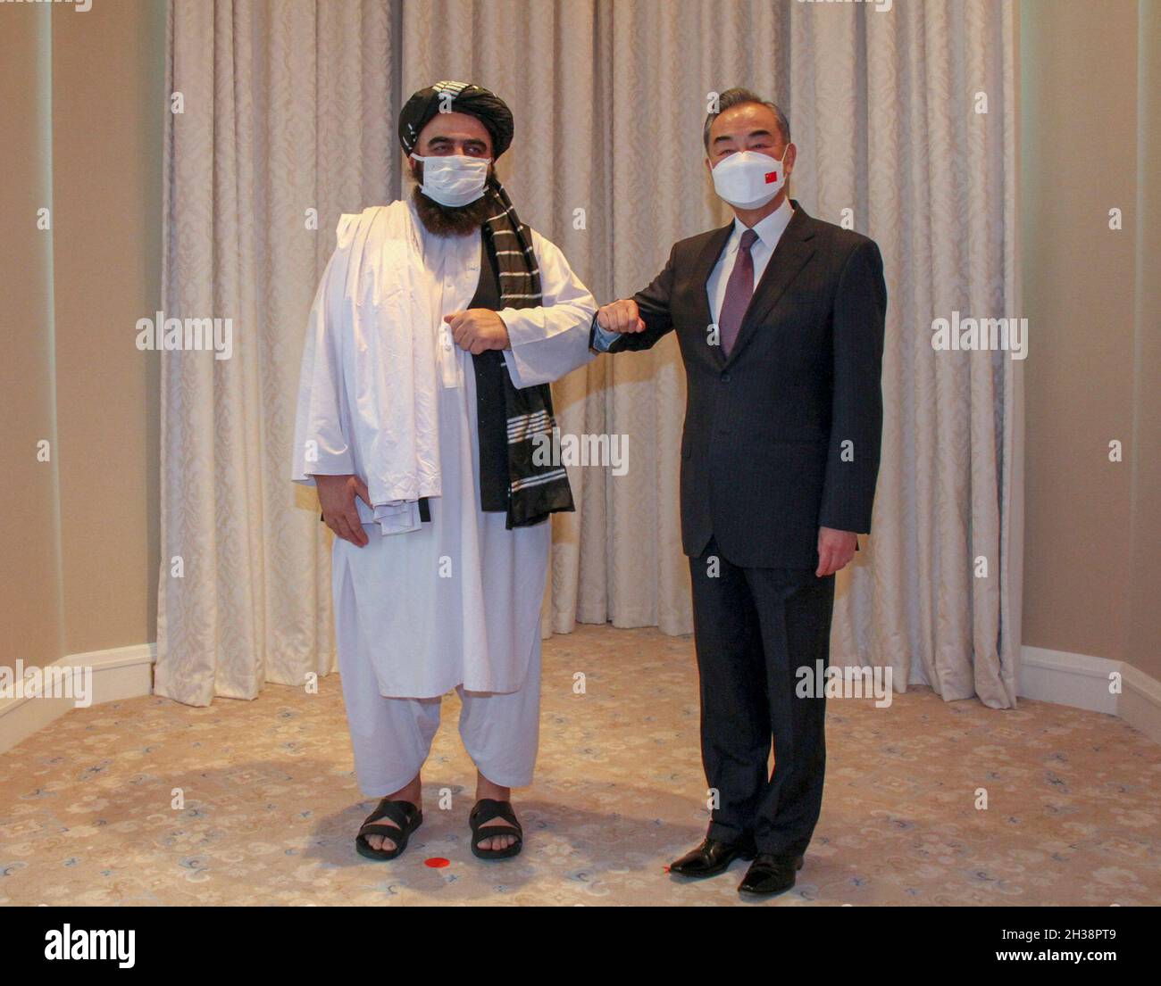 Doha, Qatar. 26th Oct, 2021. Chinese State Councilor and Foreign Minister Wang Yi (R) meets with Amir Khan Muttaqi, acting foreign minister of the Afghan Taliban's interim government, in Doha, Qatar, on Oct. 26, 2021. Credit: Yang Yuanyong/Xinhua/Alamy Live News Stock Photo