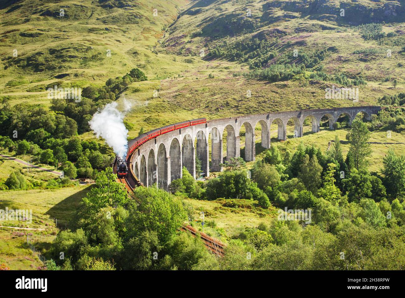 Jacobite steam train on Glenfinnan Viaduct approaching, Highlands, Scotland, United Kingdom Stock Photo