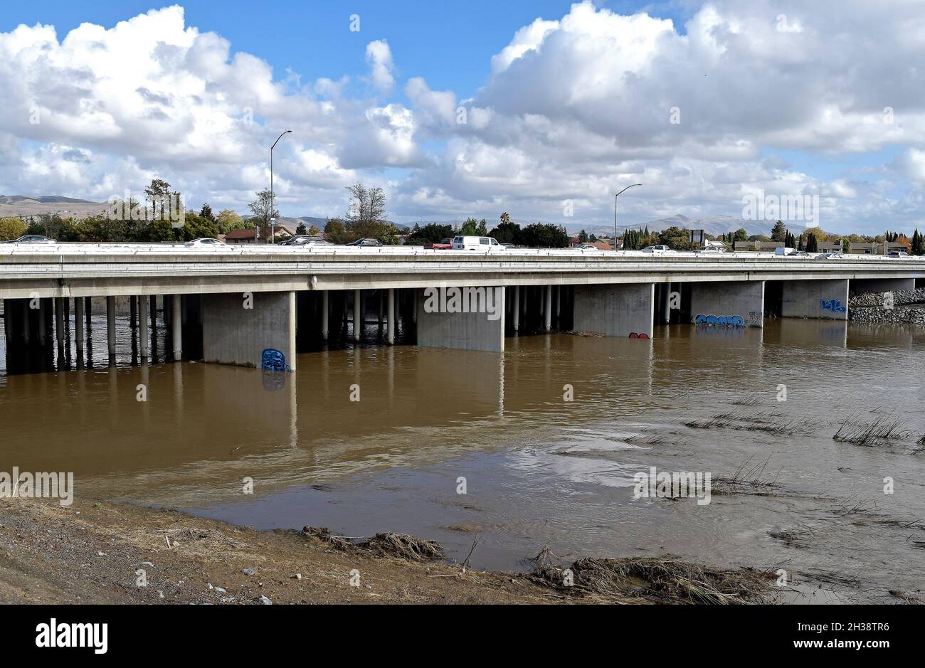 high water in the Alameda Creek flows under the 880 freeway overpass in Alameda County after a record breaking bomb' cyclone blasted the San Francisco Bay Area, California.  October 25, 2021 Stock Photo