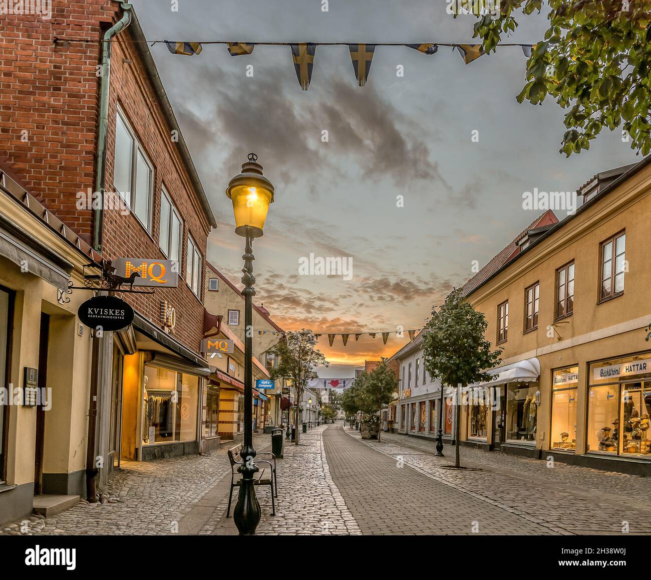 pedestrian shopping street in Ystad with a streetlight an early morning at sunrise, Ystad, Sweden, September 15, 2021 Stock Photo