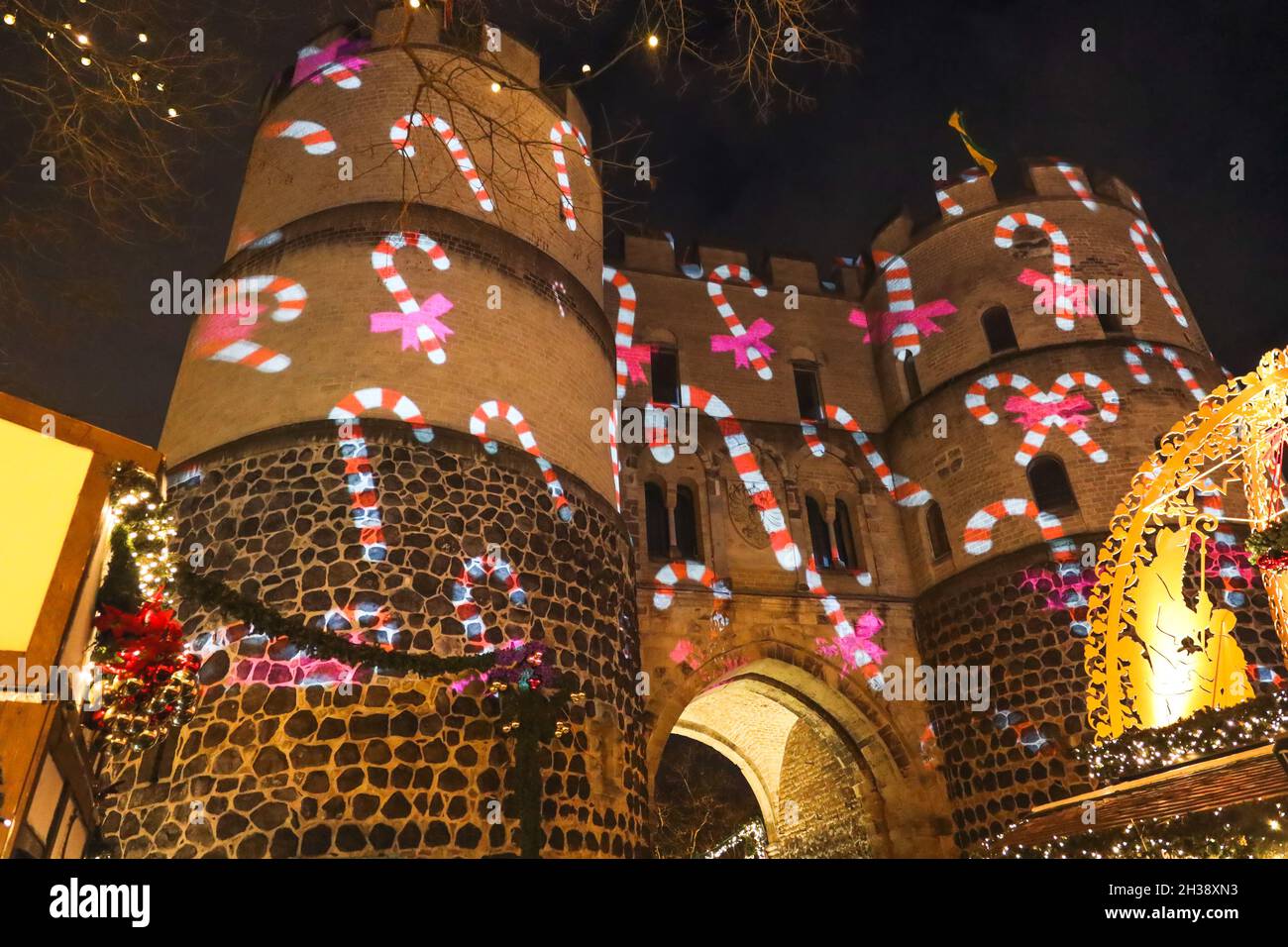 Christmas candy cane figures reflected by light show on the historical