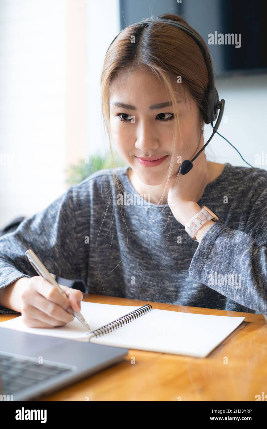 Customer service representative with a headset and work at home. business support team concept. Stock Photo