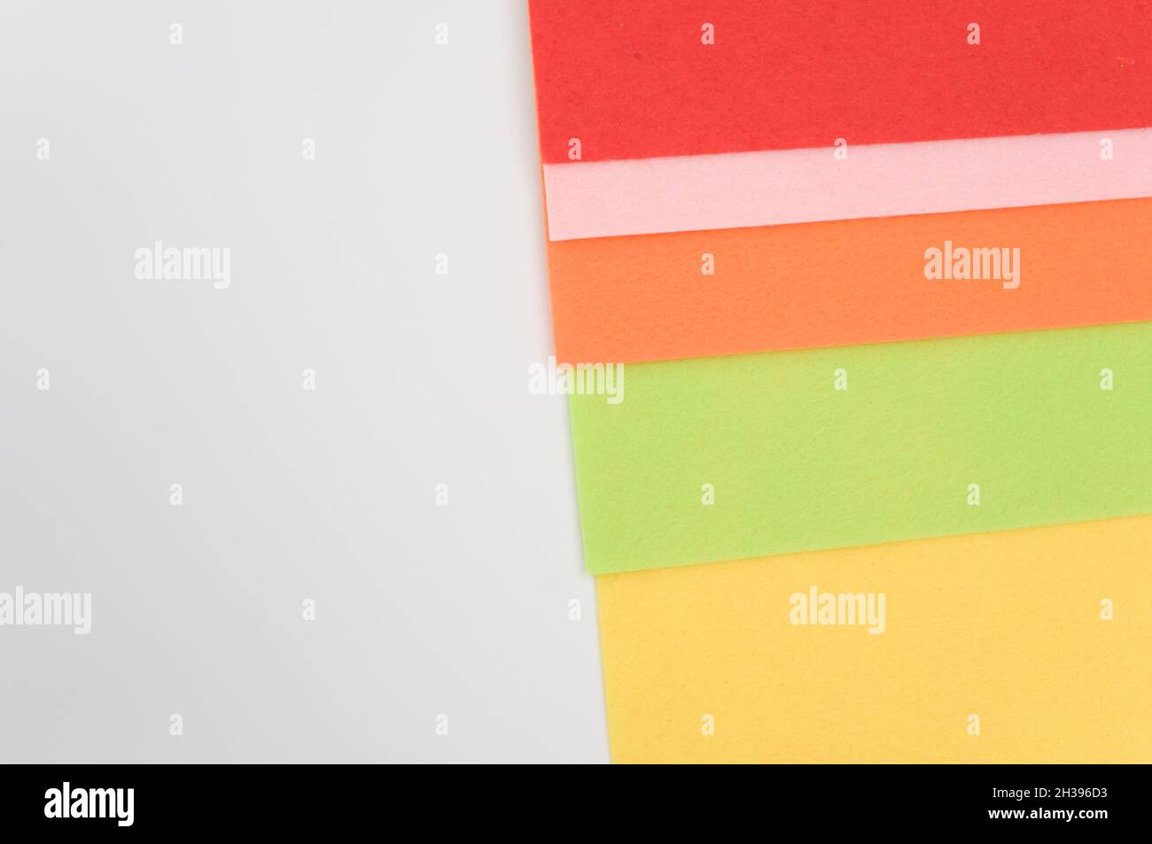 multicolored felt sheets backdrop on a white background Stock Photo - Alamy