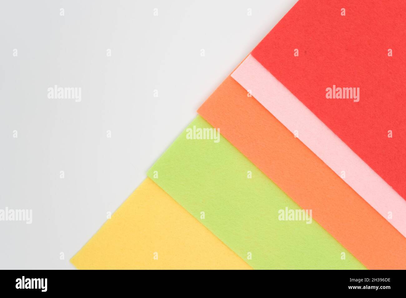 multicolored felt sheets backdrop on a white background Stock Photo - Alamy