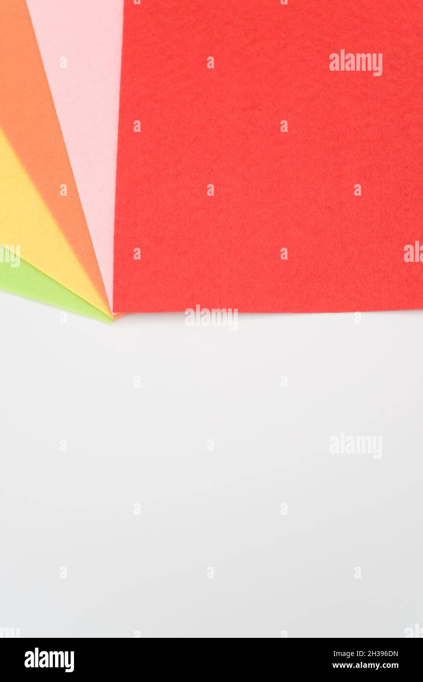 multicolored felt sheets backdrop on a white background Stock Photo - Alamy