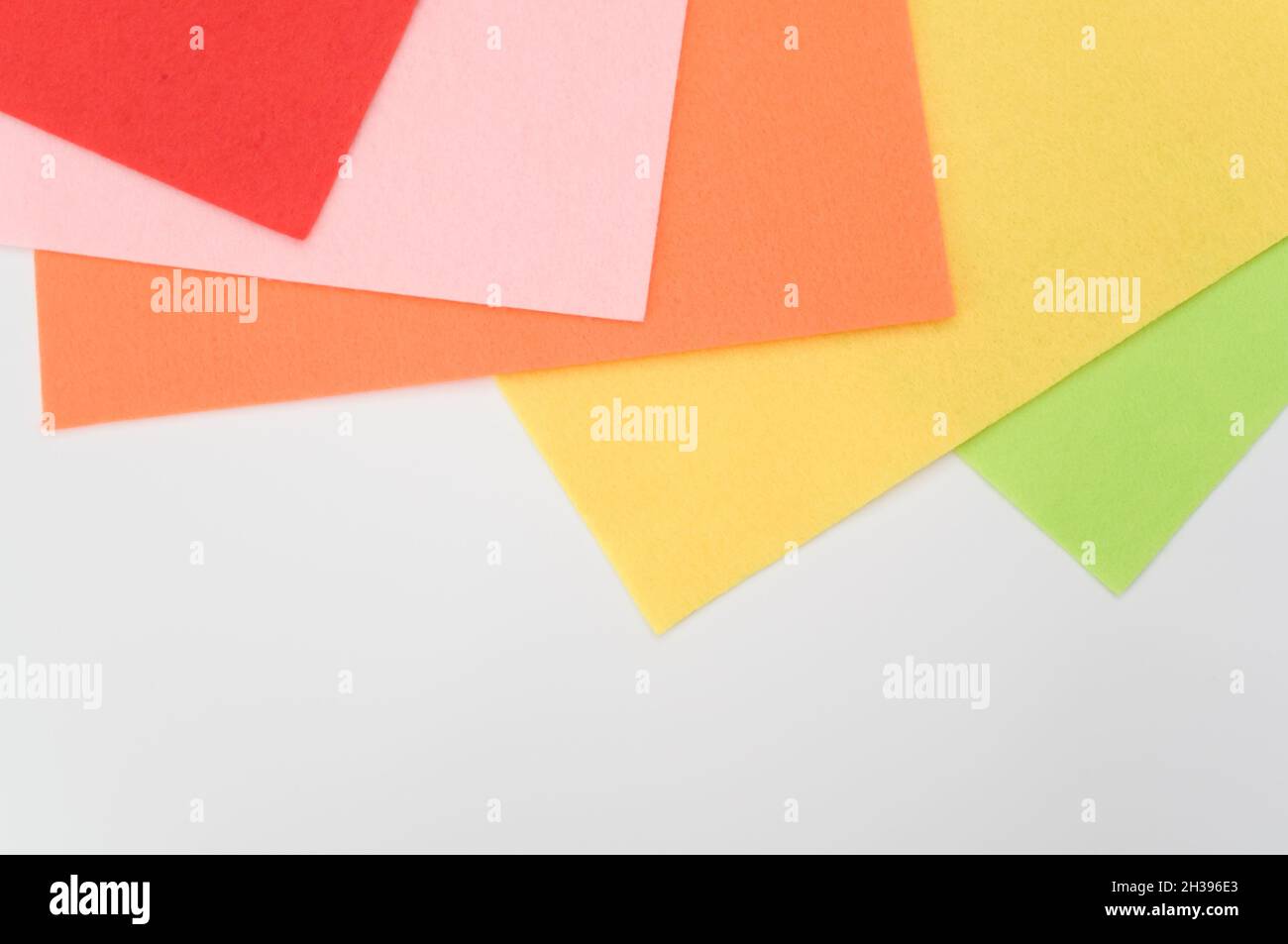 multicolored felt sheets backdrop on a white background Stock Photo - Alamy