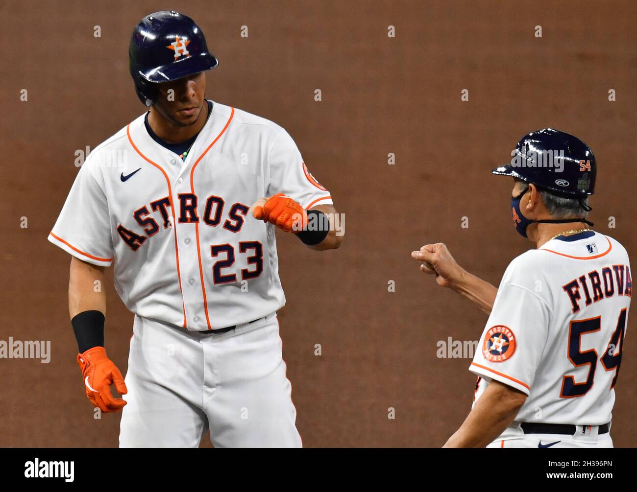 Houston, United States. 26th Oct, 2021. Houston Astros left fielder Michael  Brantley is congratulated by first base coach dan Firova after hitting a  single in the 1st inning of game one against