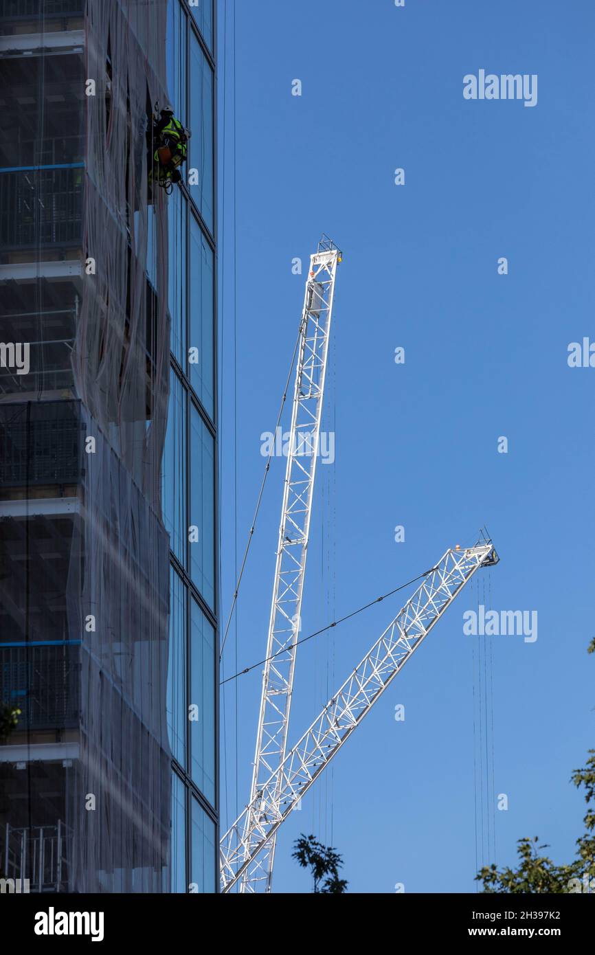 Workers on a high-rise building at Spitalfields, east London Stock Photo