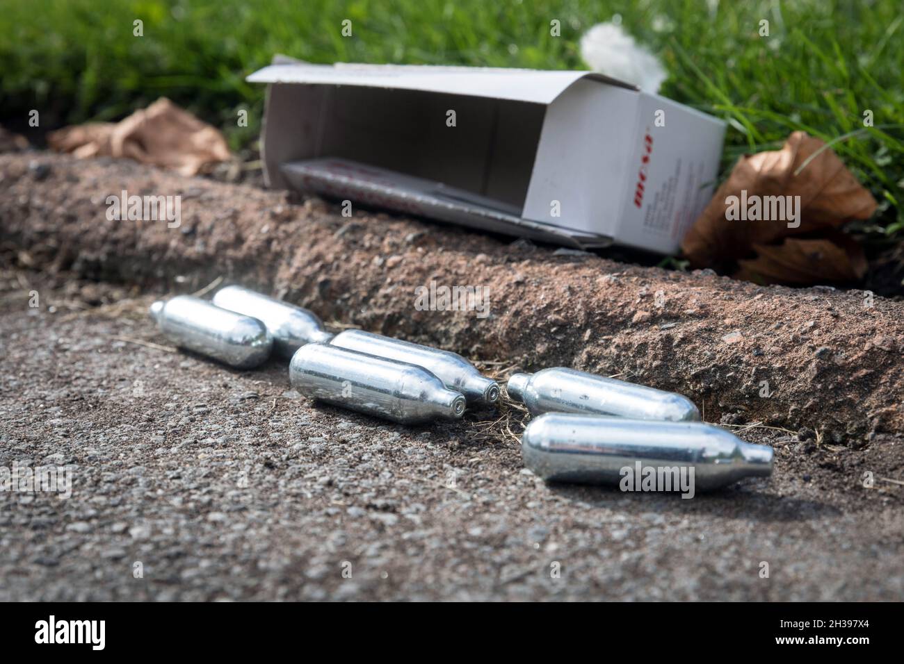 Discarded nitrous oxide capsules in a square in Liverpool city centre Stock Photo
