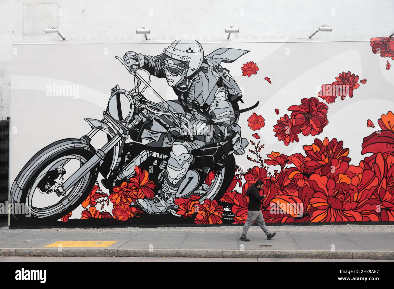Partial view of a colorful mural of a motorcycle rider with red flowers