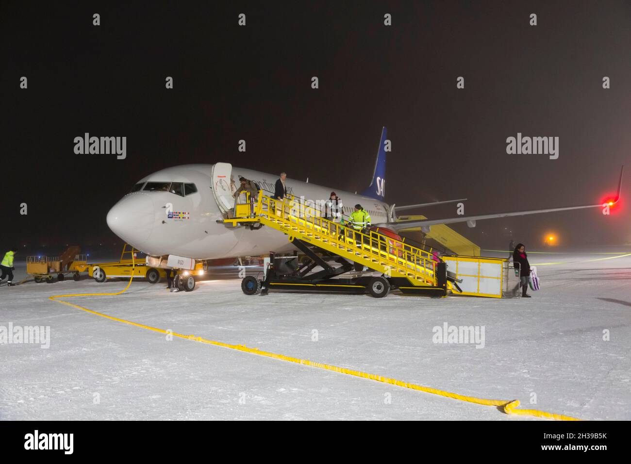 SAS, Airbus A 320 with passenger stairs in winter on snowy tarmac, Kiruna Swedavia Airport, Lapland, northern Sweden, Sweden Stock Photo