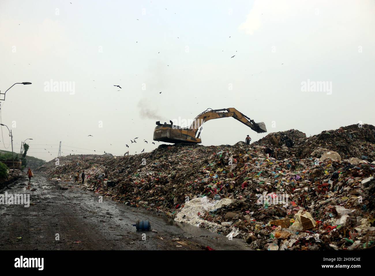 Non Exclusive People recycle nonbiodegradable waste at a garbage dump