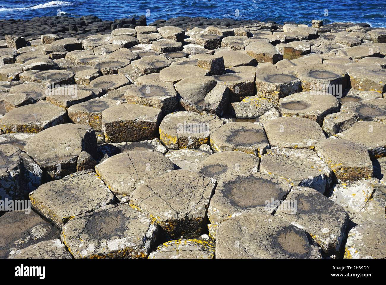 Weathered uneven surface of ancient volcanic rock formations at the Giant's Causeway, located in Country Antrim, on the coast of Northern Ireland Stock Photo