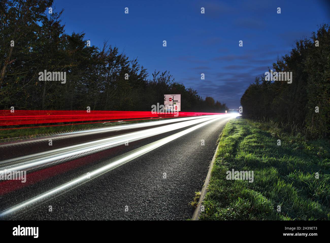 Light trails on a busy trunk road into the city of cambridge early morning, as commuters travel to Cambridge city Stock Photo