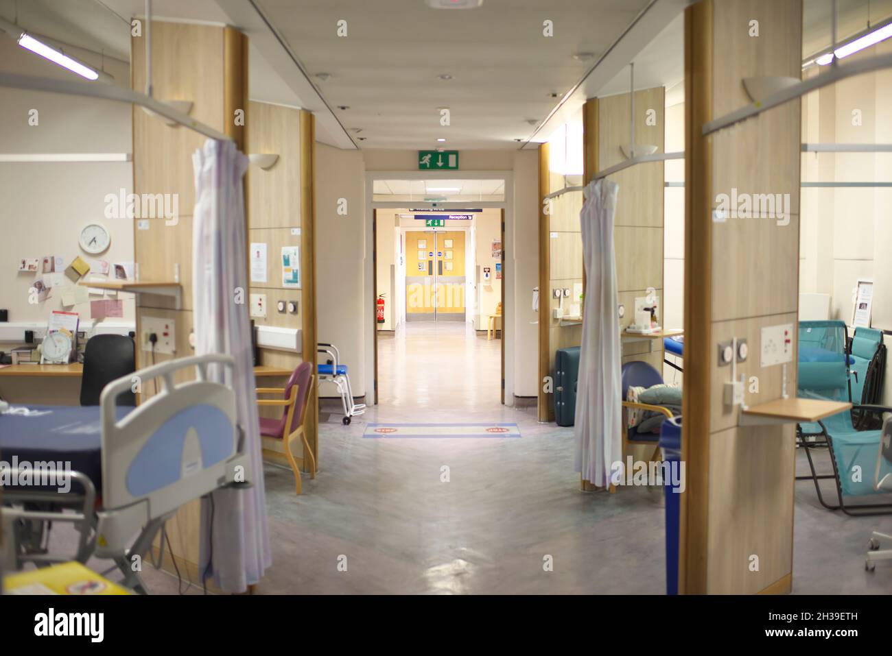 Hospital ward in a UK NHS hospital, completely empty, showing empty beds and chairs in a usually busy hospital Stock Photo