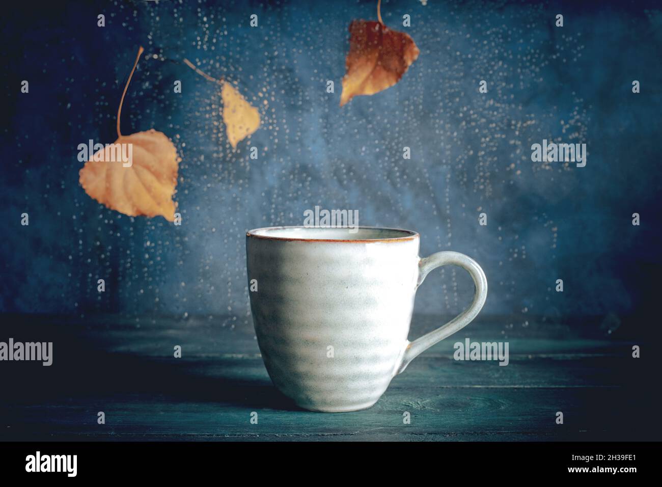 Rainy Day With A Cup Of Tea Autumn Leaves Rain Behind The Window A Warm Drink Stock Photo Alamy