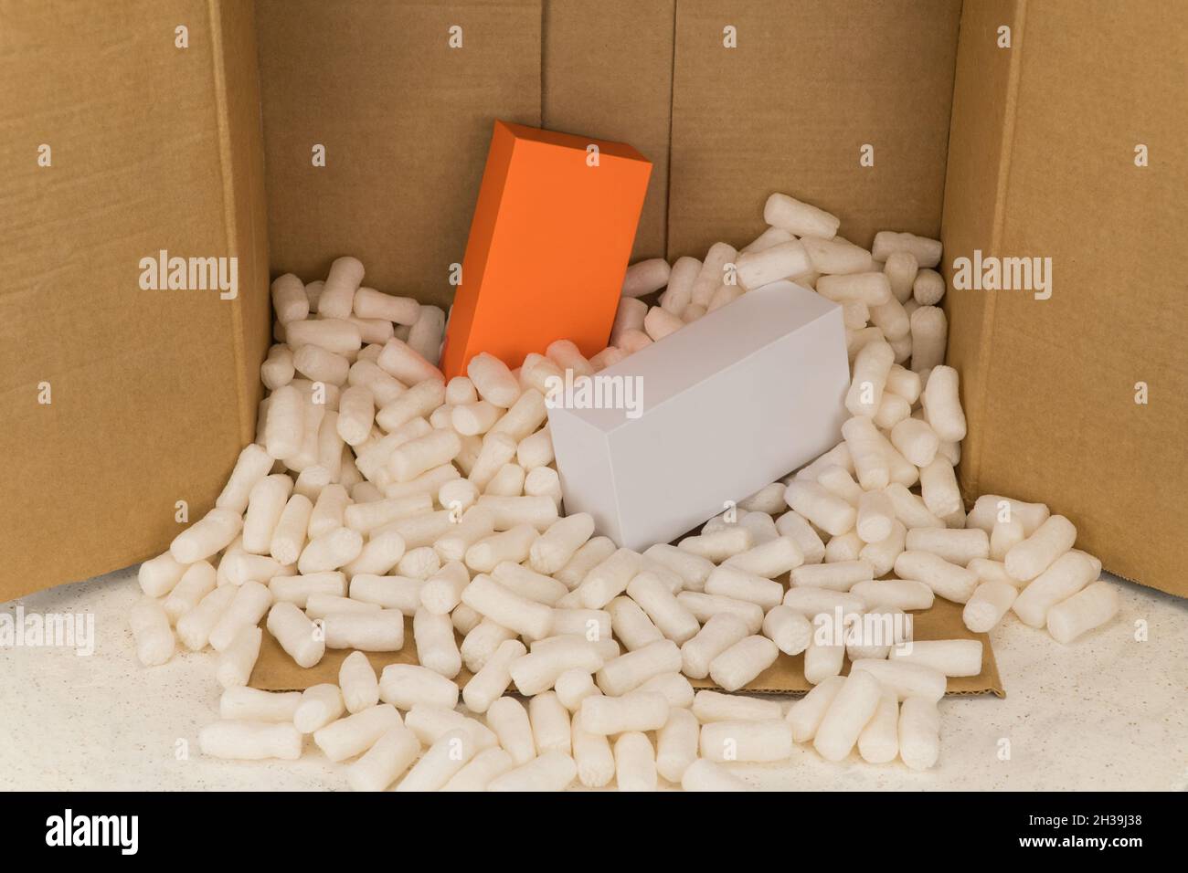 Cardboard box with styrofoam filler for safe packaging. Gift package Stock Photo