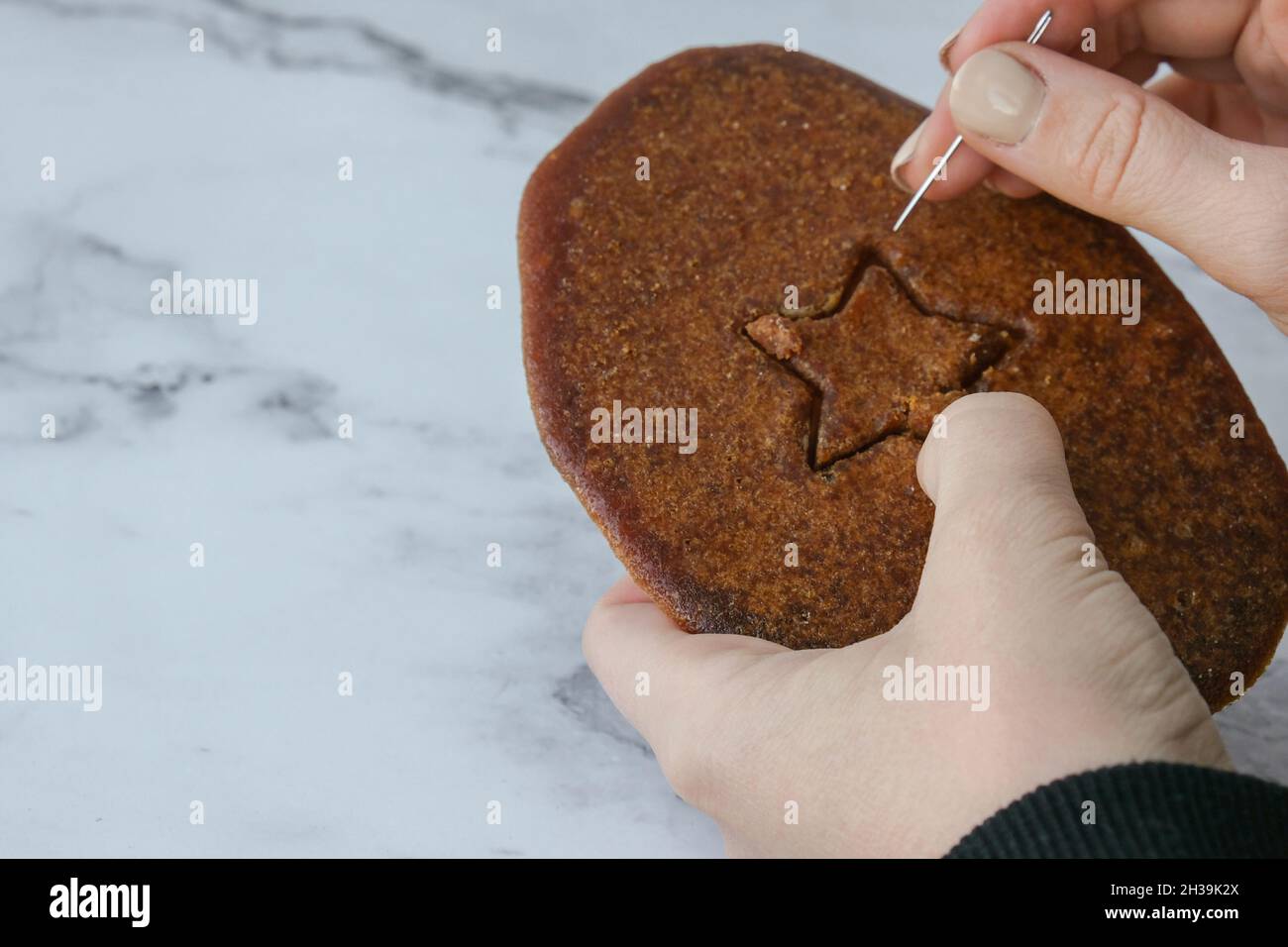 Playing Korean Dalgona or Ppopgi honeycomb candy from Squid Game challenge.  Star shape. Homemade sugar candy. Failed game. Game over. Homemade Old Fas  Stock Photo - Alamy