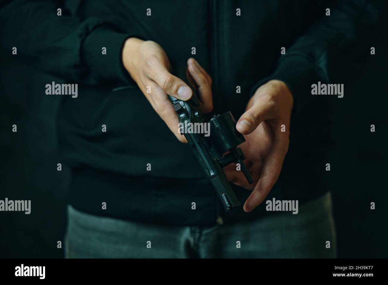 Reloading gun closeup. Men's hands check for bullets in revolver