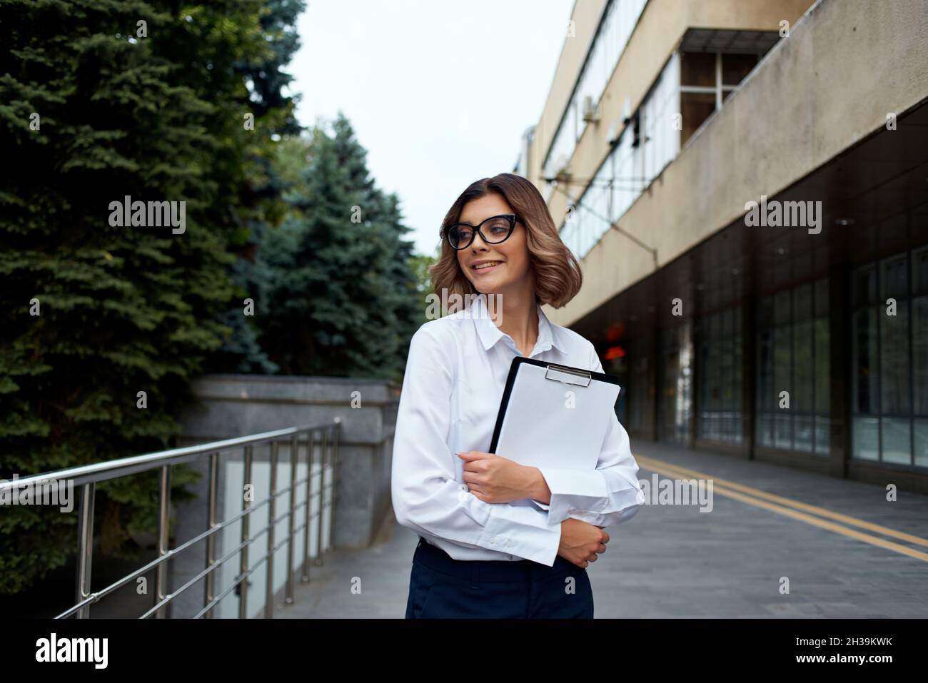 Business woman in white shirt on the street with work documents Stock ...