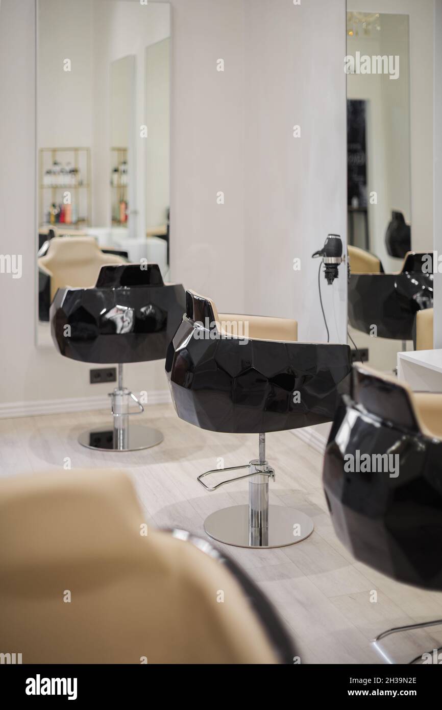 Interior of beauty salon with chairs and mirrors. Furniture in modern  hairdressing Stock Photo - Alamy