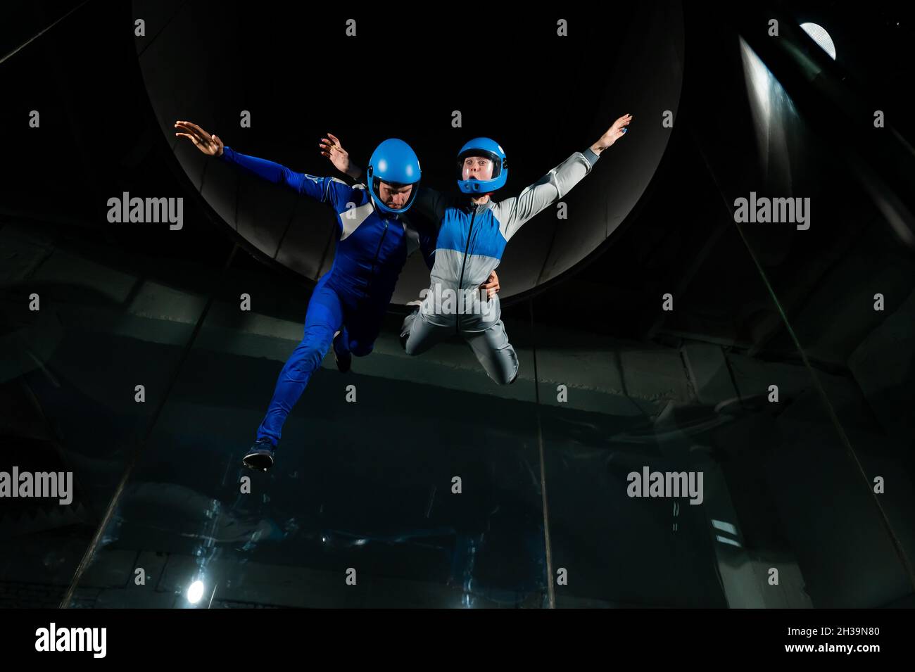 A man and a woman enjoy flying together in a wind tunnel. Free fall ...