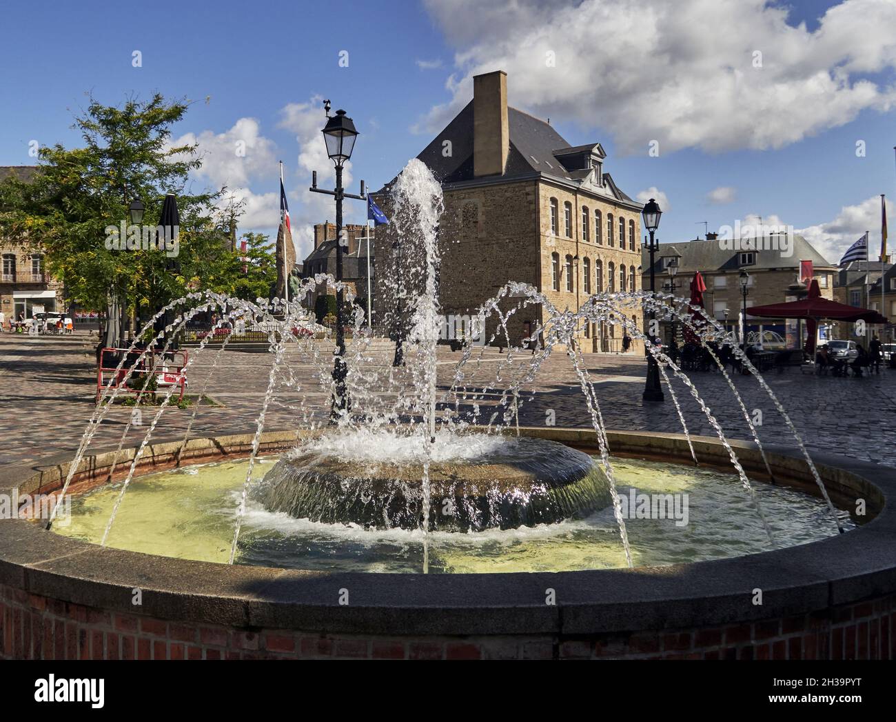 France, Fougeres.  This vast pedestrian square is in the heart of the upper town and there is a fountain, public benches, a few terraces and many shop Stock Photo