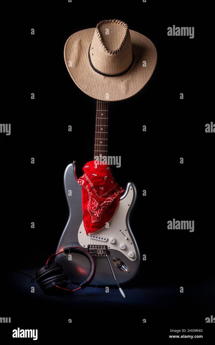 Silver electric guitar with red bandana hat and headphones Stock Photo -  Alamy