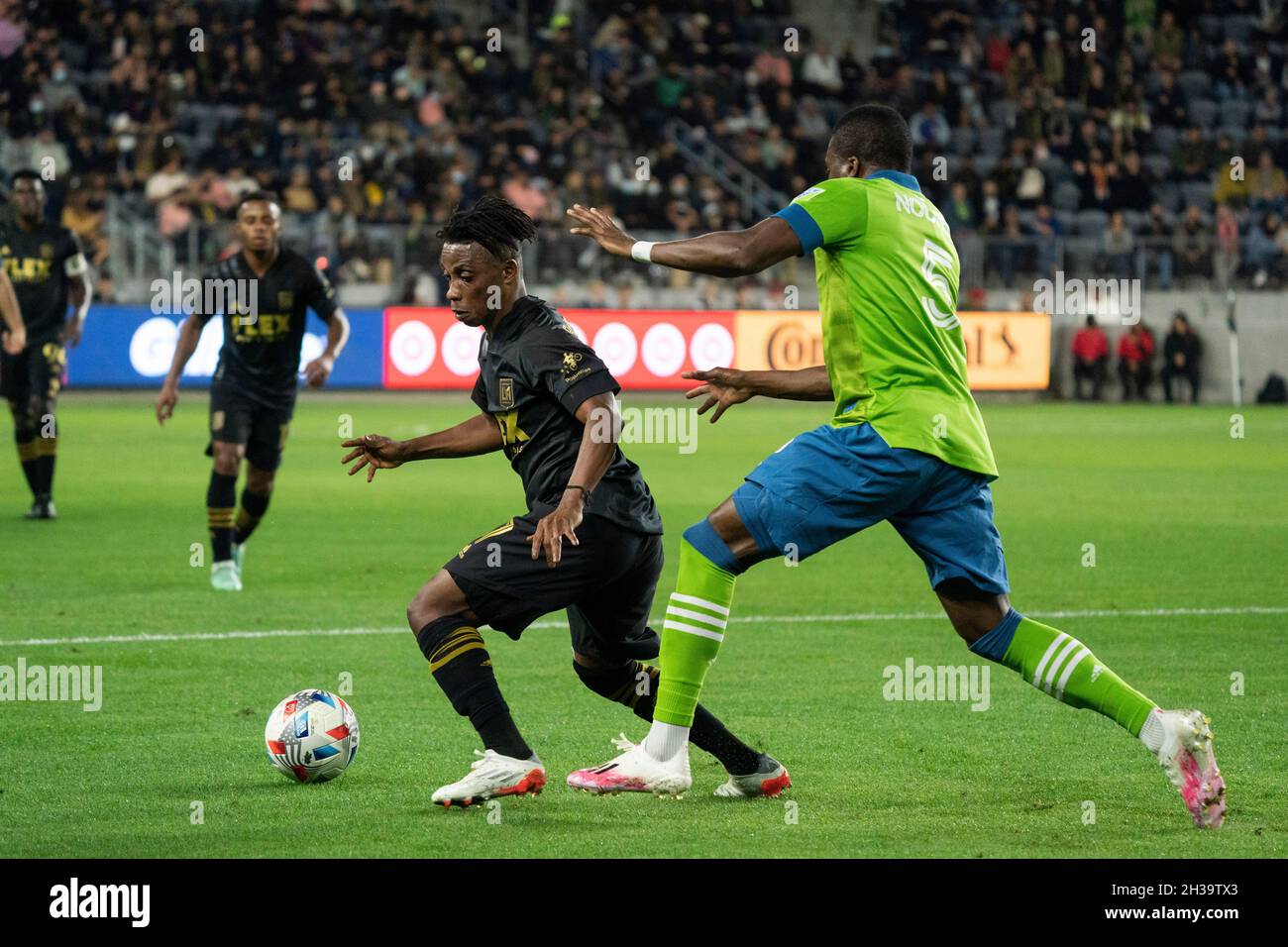 SEATTLE, WA - MAY 16: Seattle Sounders defender Nouhou Tolo (5) slide  tackles the ball away from Los Angeles FC forward Latif Blessing (7) during  an MLS match between LAFC and the