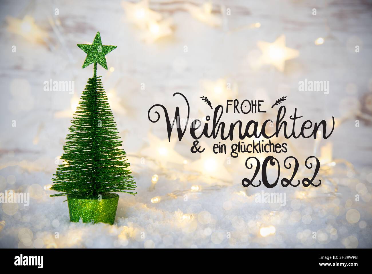 Green Christmas Tree, Lights, Star, Snow, Glueckliches 2022 Means Happy 2022 Stock Photo - Alamy