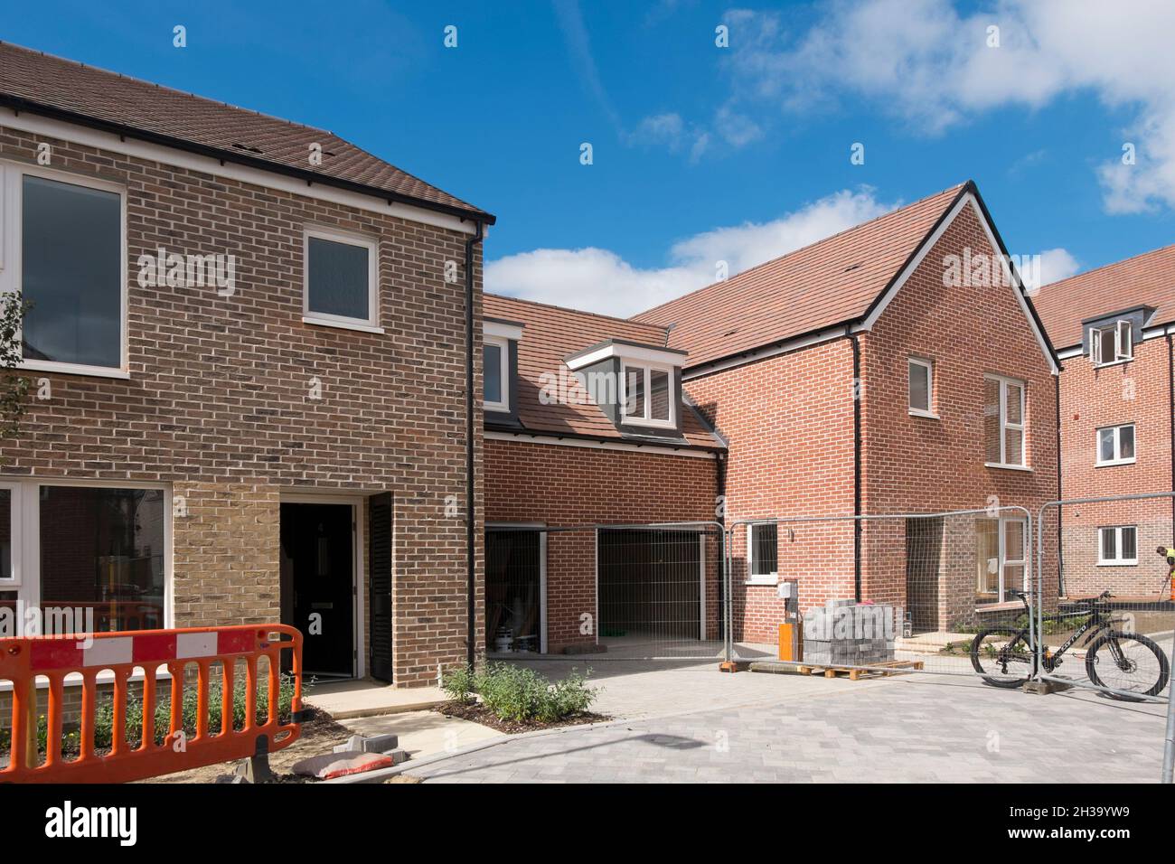 New houses with garages in Joseph Lancaster Lane, the new development in north Chichester, West Sussex, England, UK. Stock Photo
