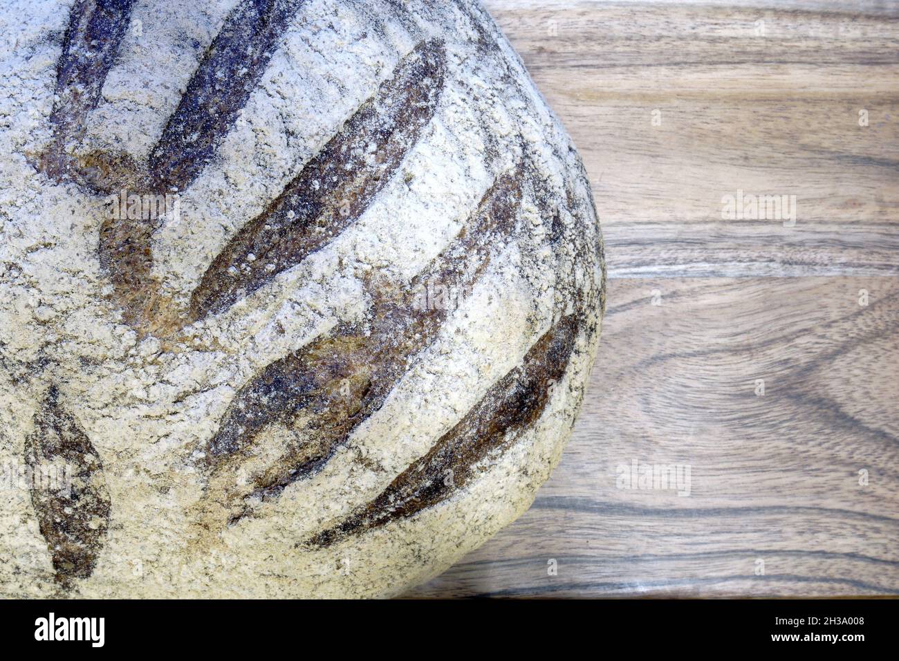 Close up of sourdough rye bread on wooden table, background Stock Photo