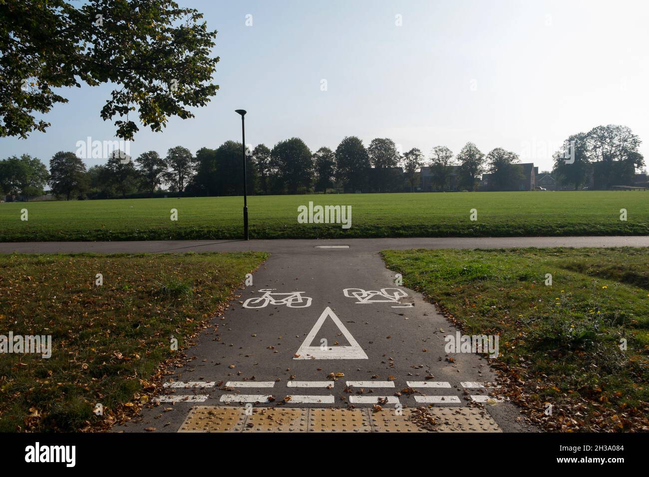 The cycle path surrounding the cricket pitch at Keepers Green, the new development in north Chichester, West Sussex, England, UK. Stock Photo