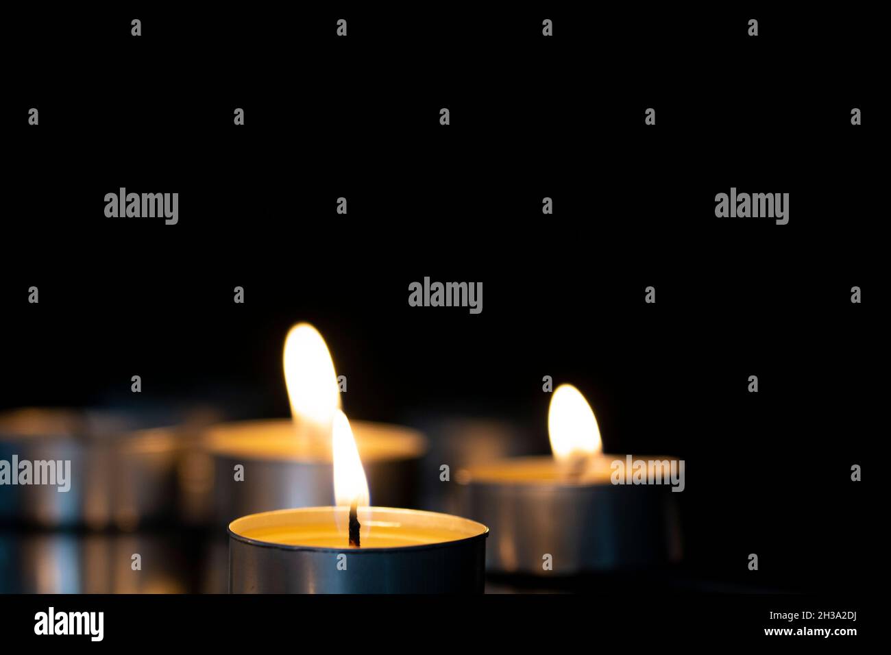 small candles are burning on the mirror Stock Photo