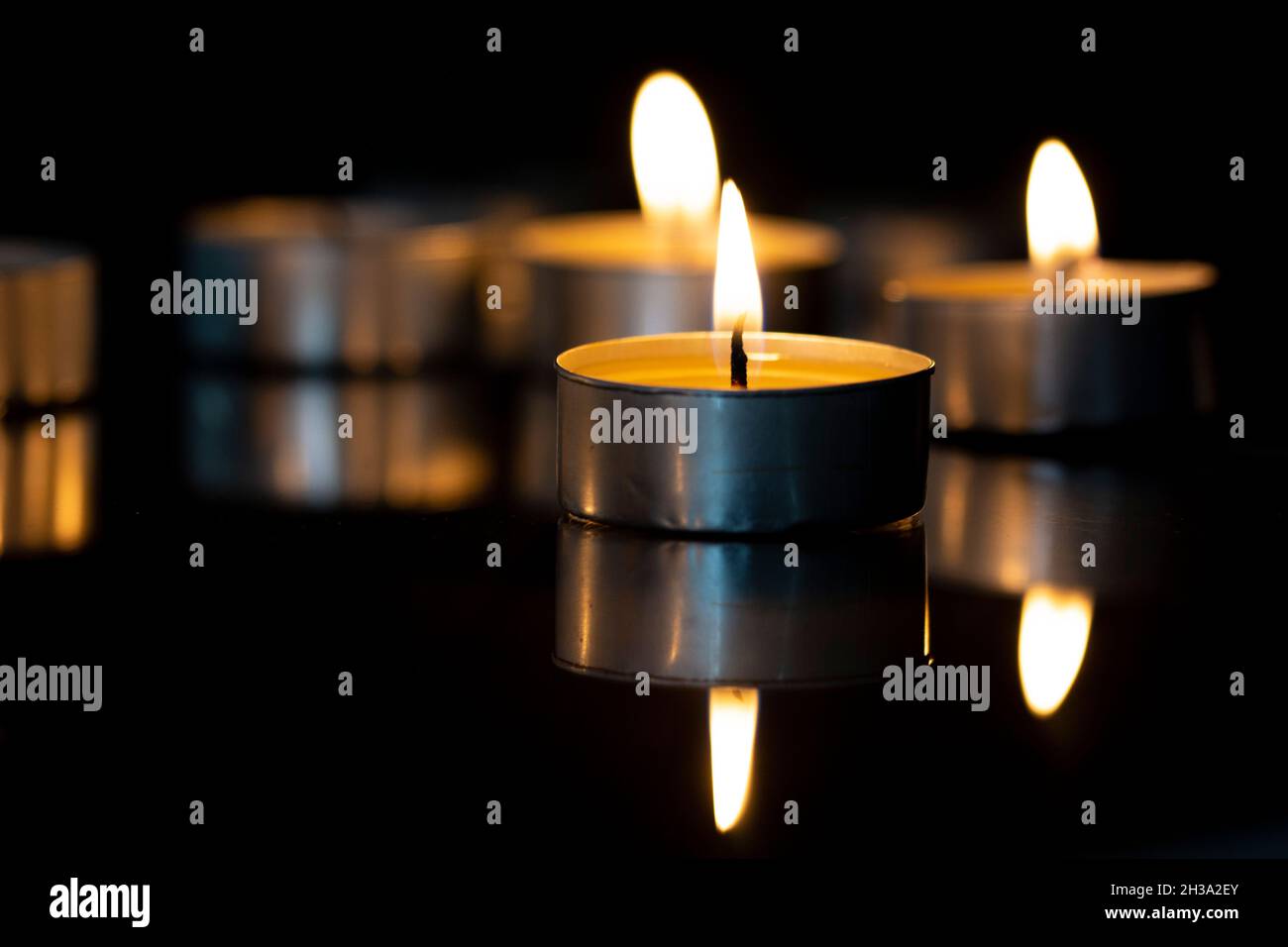 small candles are burning on the mirror Stock Photo