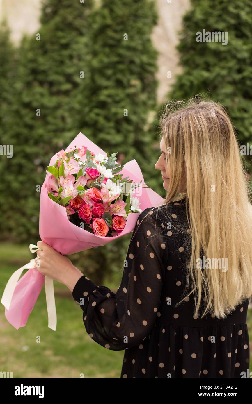 holding flower bouquet