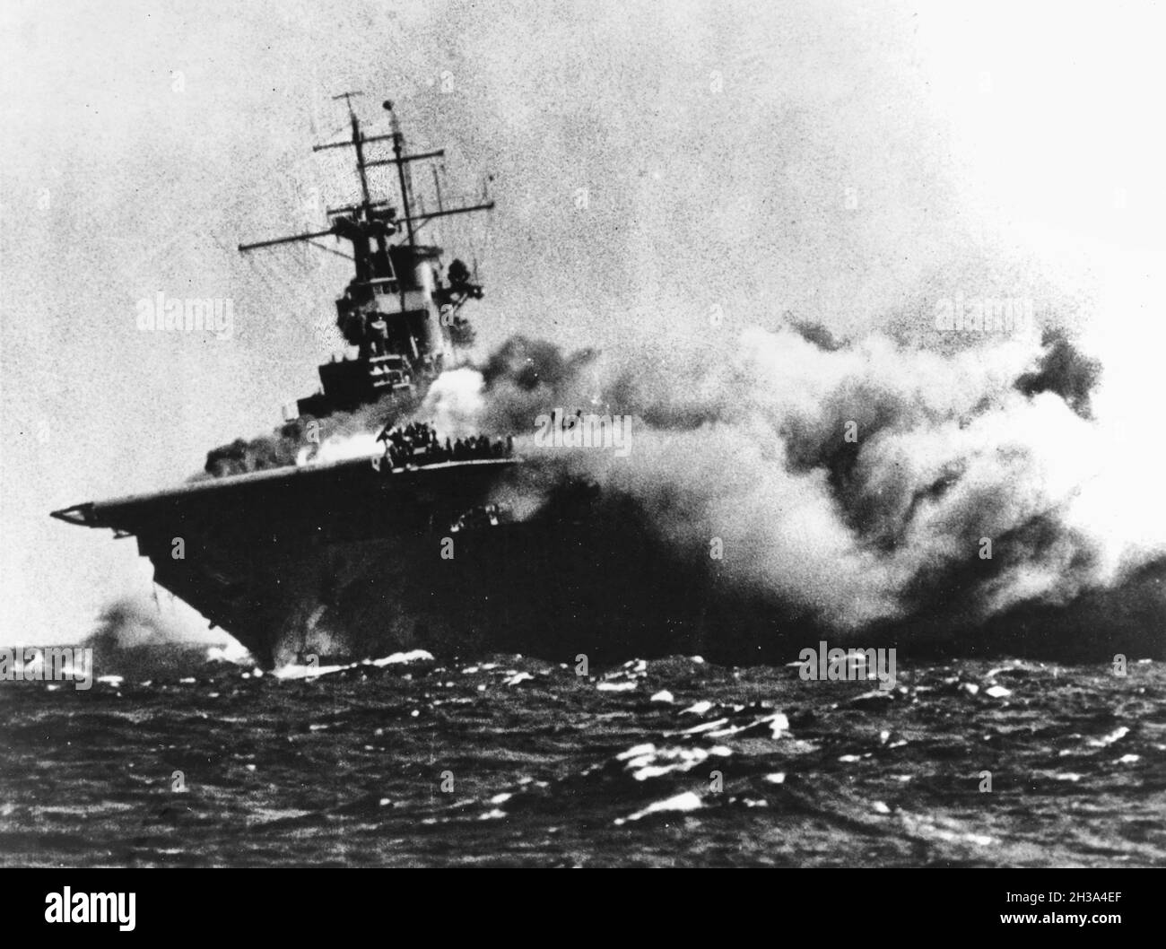 The U.S. aircraft carrier USS Wasp (CV-7) burning after receiving three torpedo hits from the Japanese submarine I-19 east of the Solomons, 15 September 1942. Stock Photo