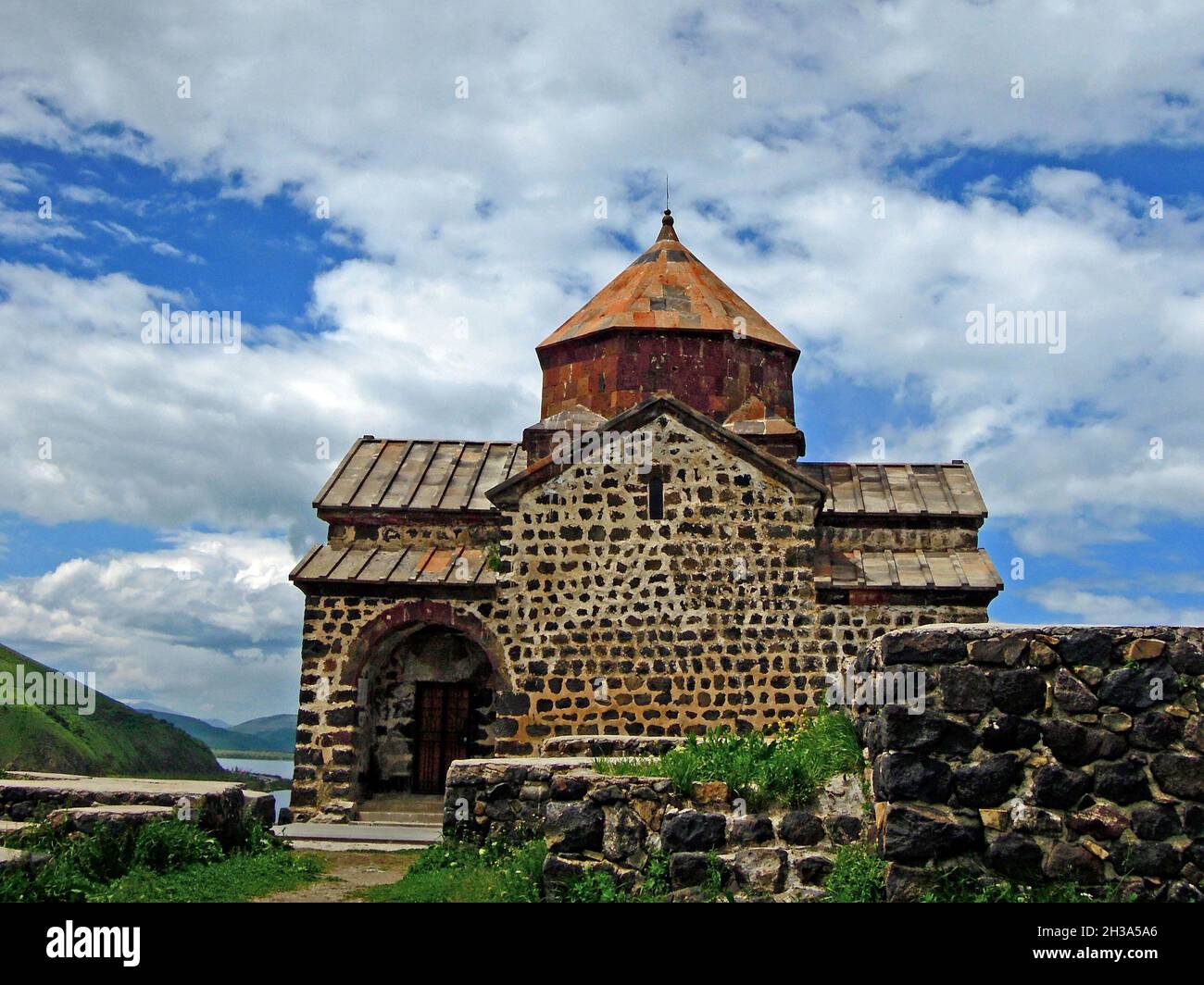 Side view onto Surp Arakelots church in Armenia, one of oldest apostolic churches on the peninsula Sevan. Founded in 874 AD. It's one of most popular Stock Photo