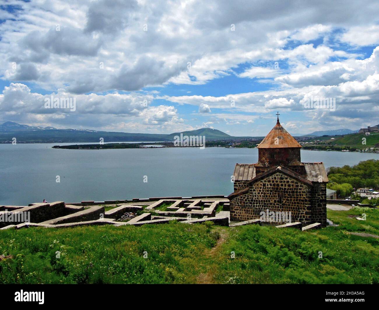 Panoramic view onto Surp Astvatsatsin church and Lake Sevan, Armenia. Sevanavank monastery complex & lake are most of popular tourist attractions near Stock Photo
