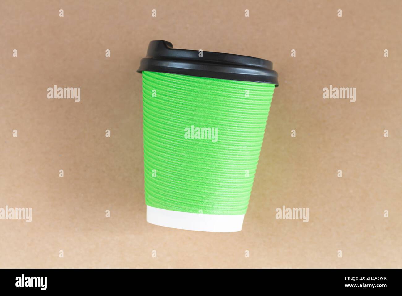 Single disposable green paper cup with cap top view Stock Photo - Alamy