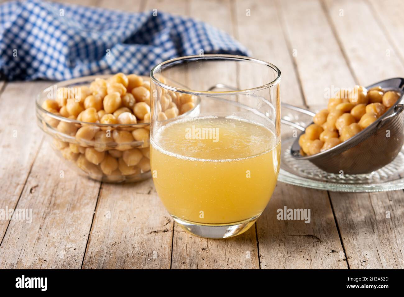 Chickpea water aquafaba on wooden table. Egg substitute in pastry Stock
