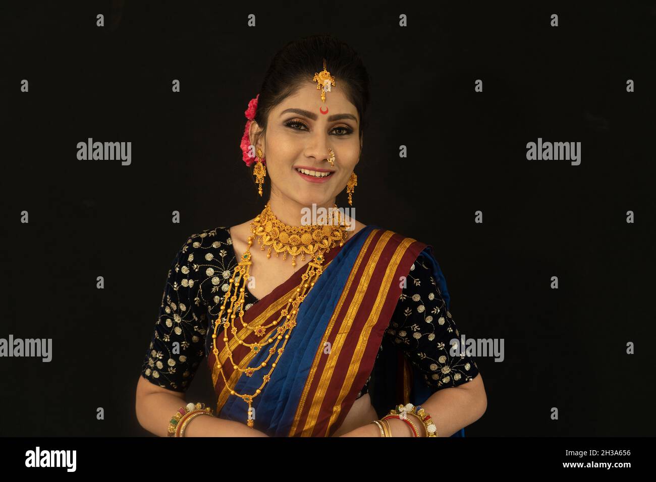 Woman in traditional Maharastrian attire look. Facing camera. Black  background Stock Photo - Alamy