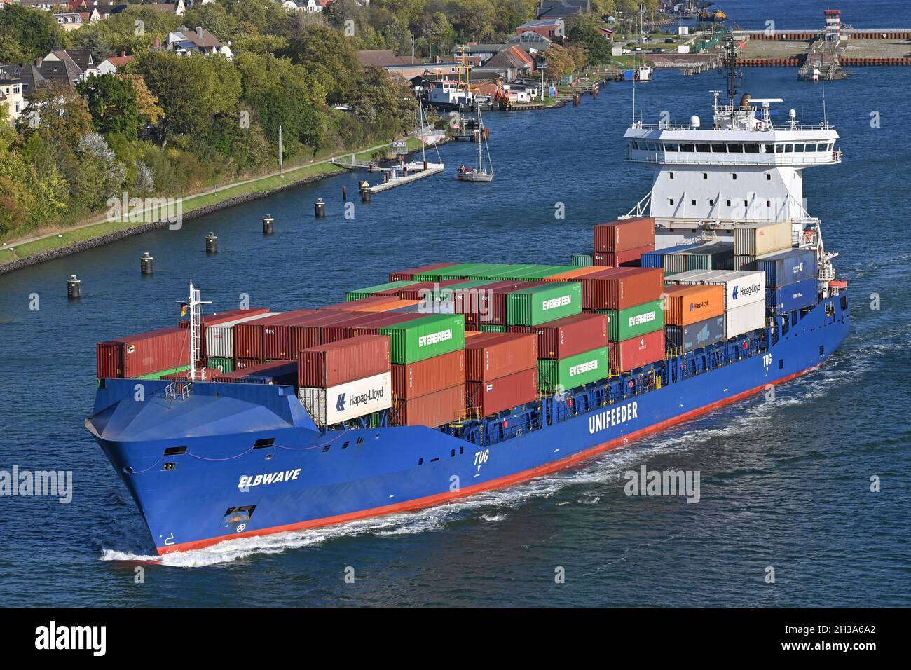 Containership ELBWAVE passing the Kiel Canal Stock Photo