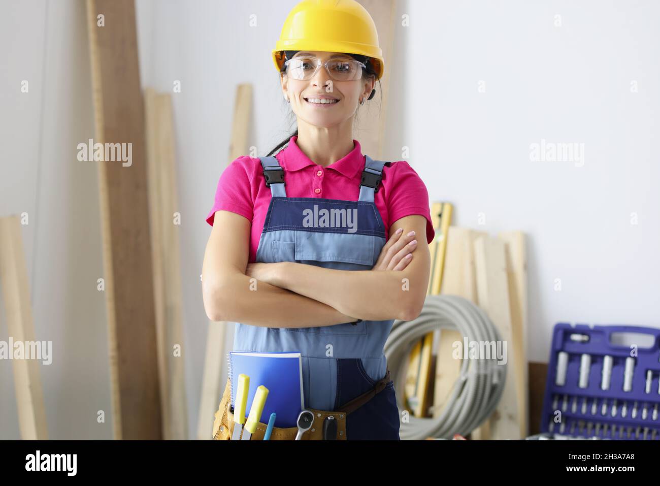 Smiling confident female worker in room Stock Photo