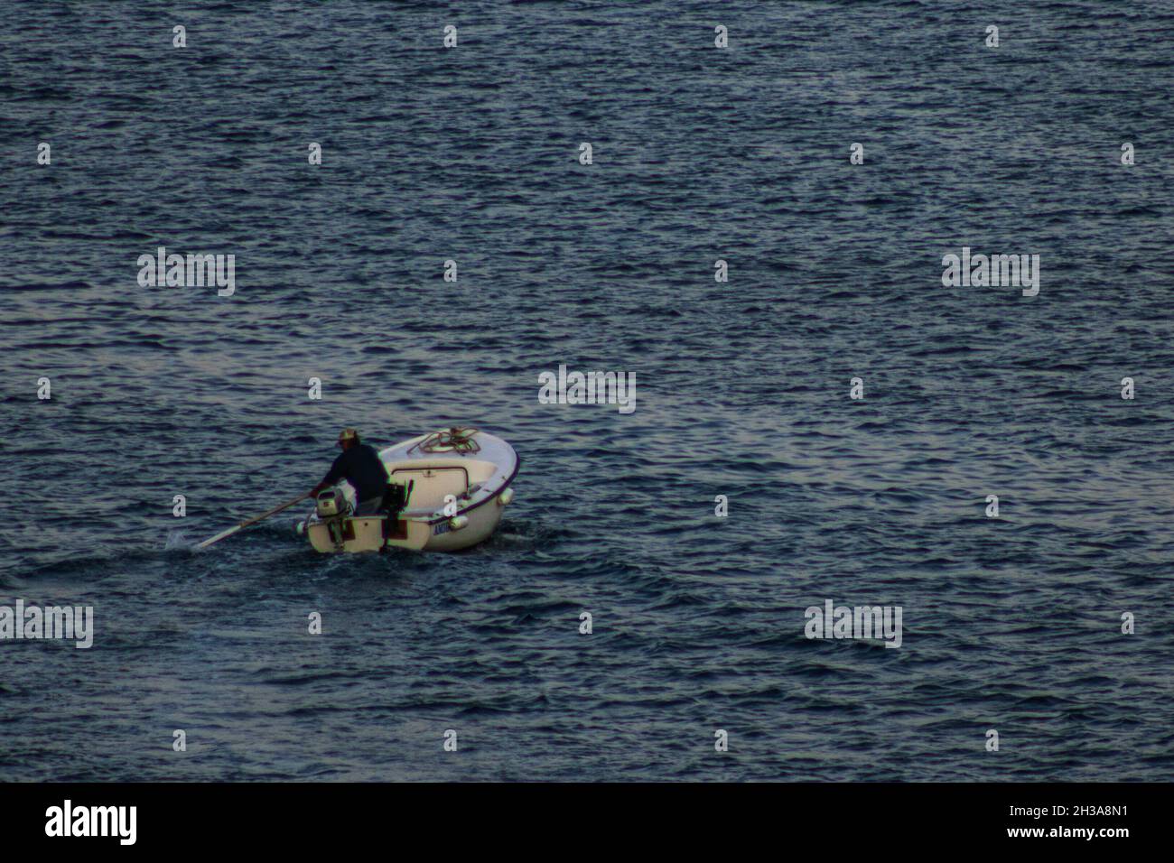 Fisherman on a boat in the middle of the sea Stock Photo - Alamy