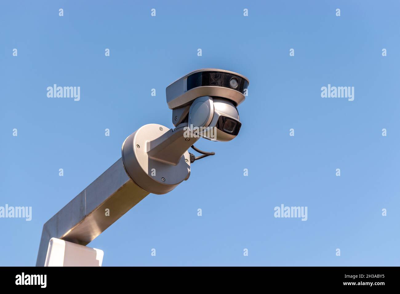 Street surveillance camera on sky background. Stock Photo